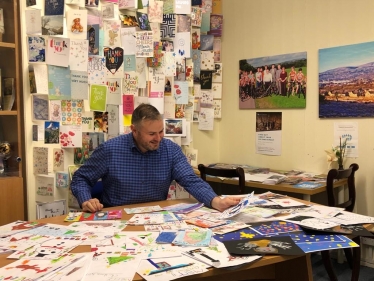 Andrew selecting the winning entry from hundreds of entries 